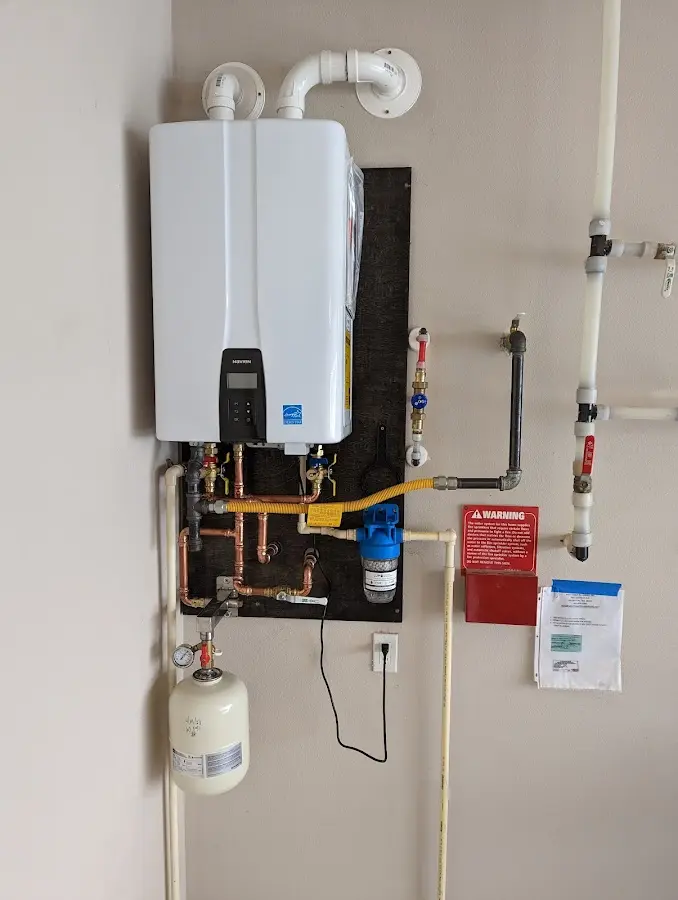 Professional plumber installing copper piping in a Lynden home